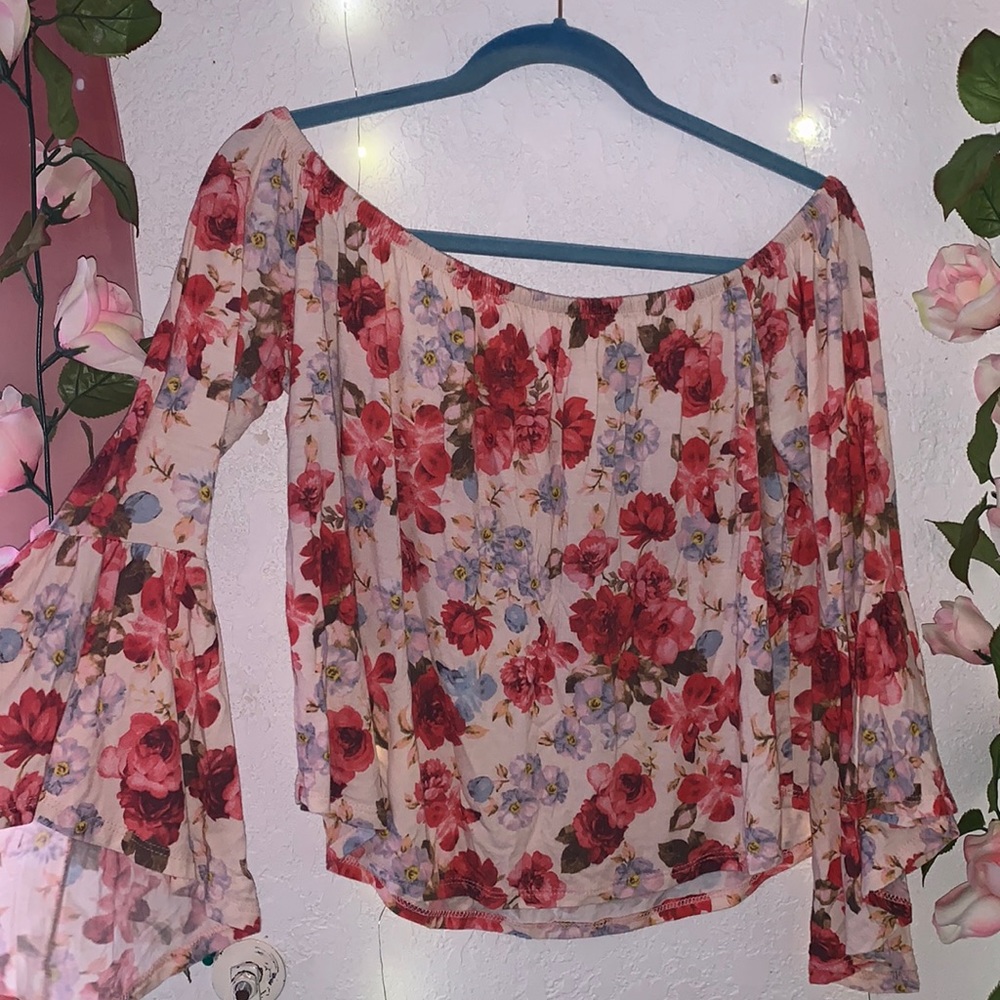 HOT LUCX COUTURE blouse with a floral design.
